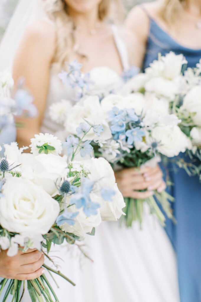 Summer garden-style Bride's bouquet with white garden roses and light blue delphiniums. 
